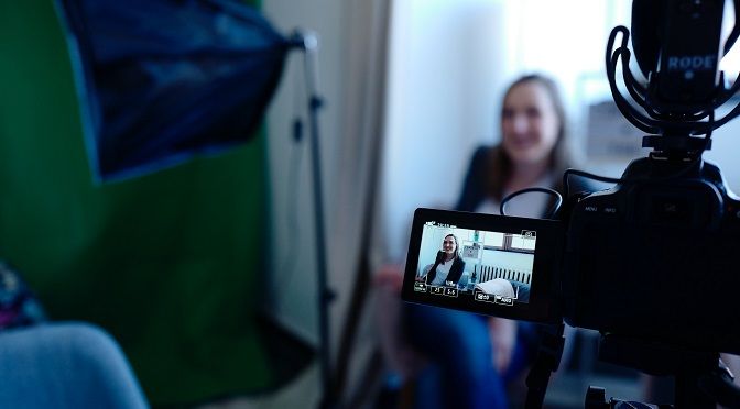 A women recording video in his office